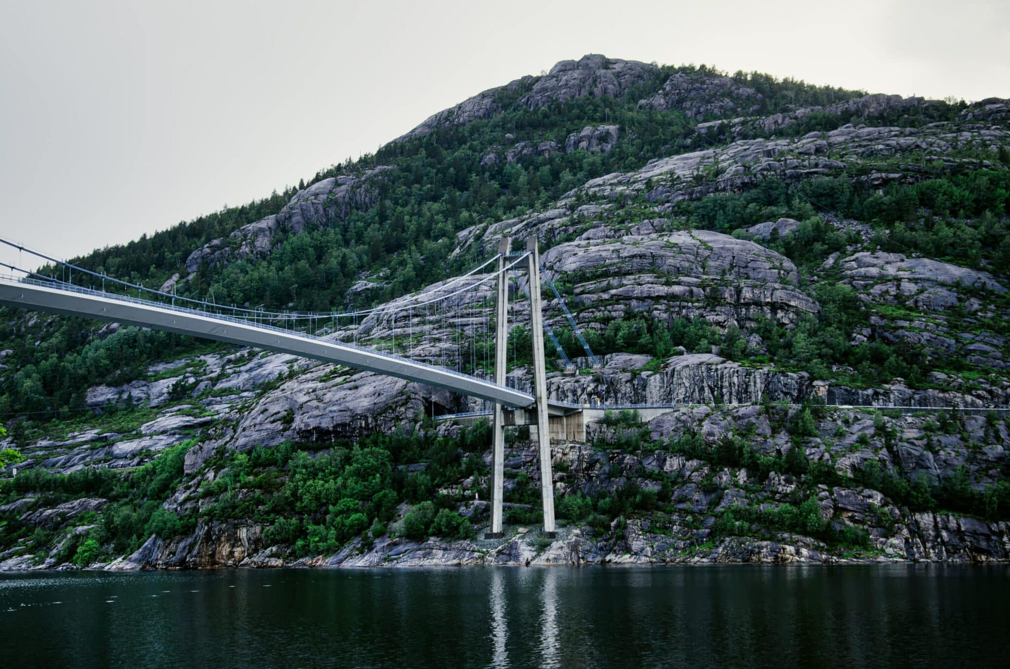 Suspension bridge in Norway with rocks in the background