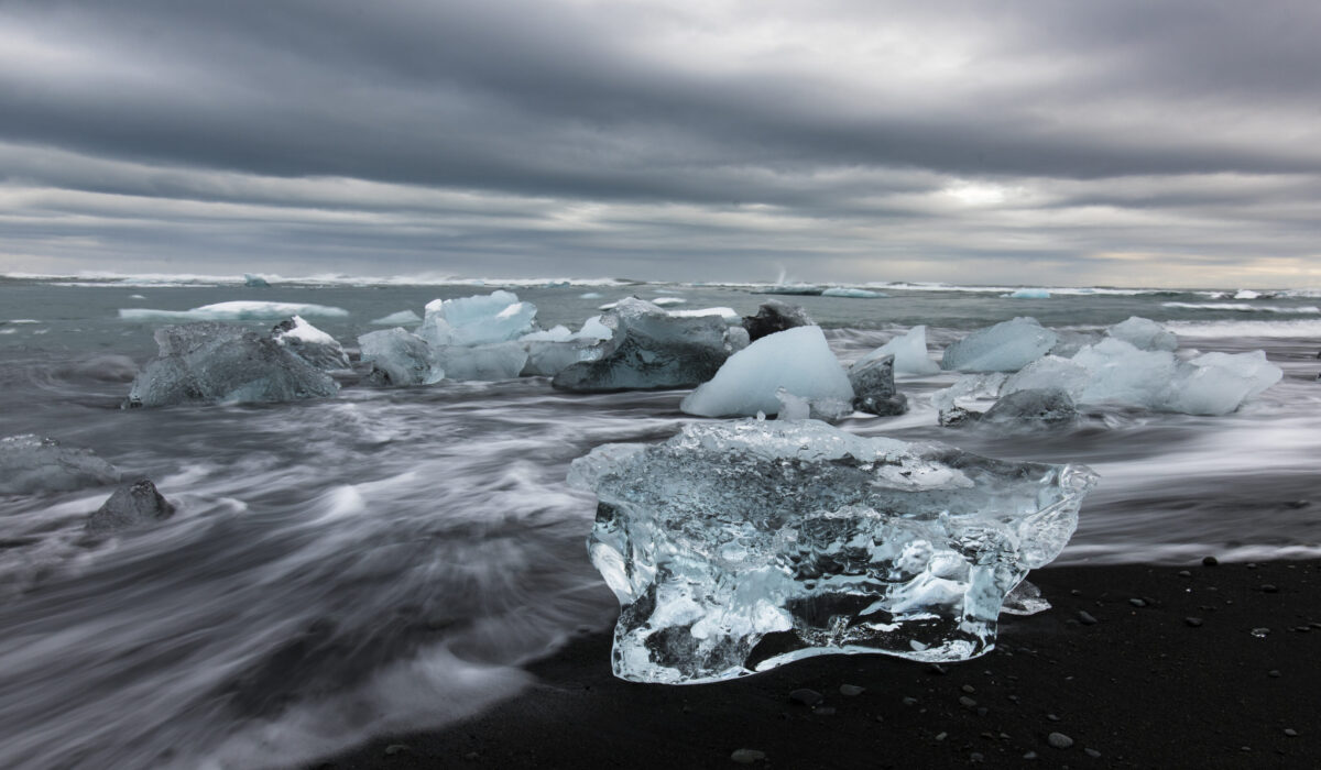 pieces of ice on black sand in Iceland