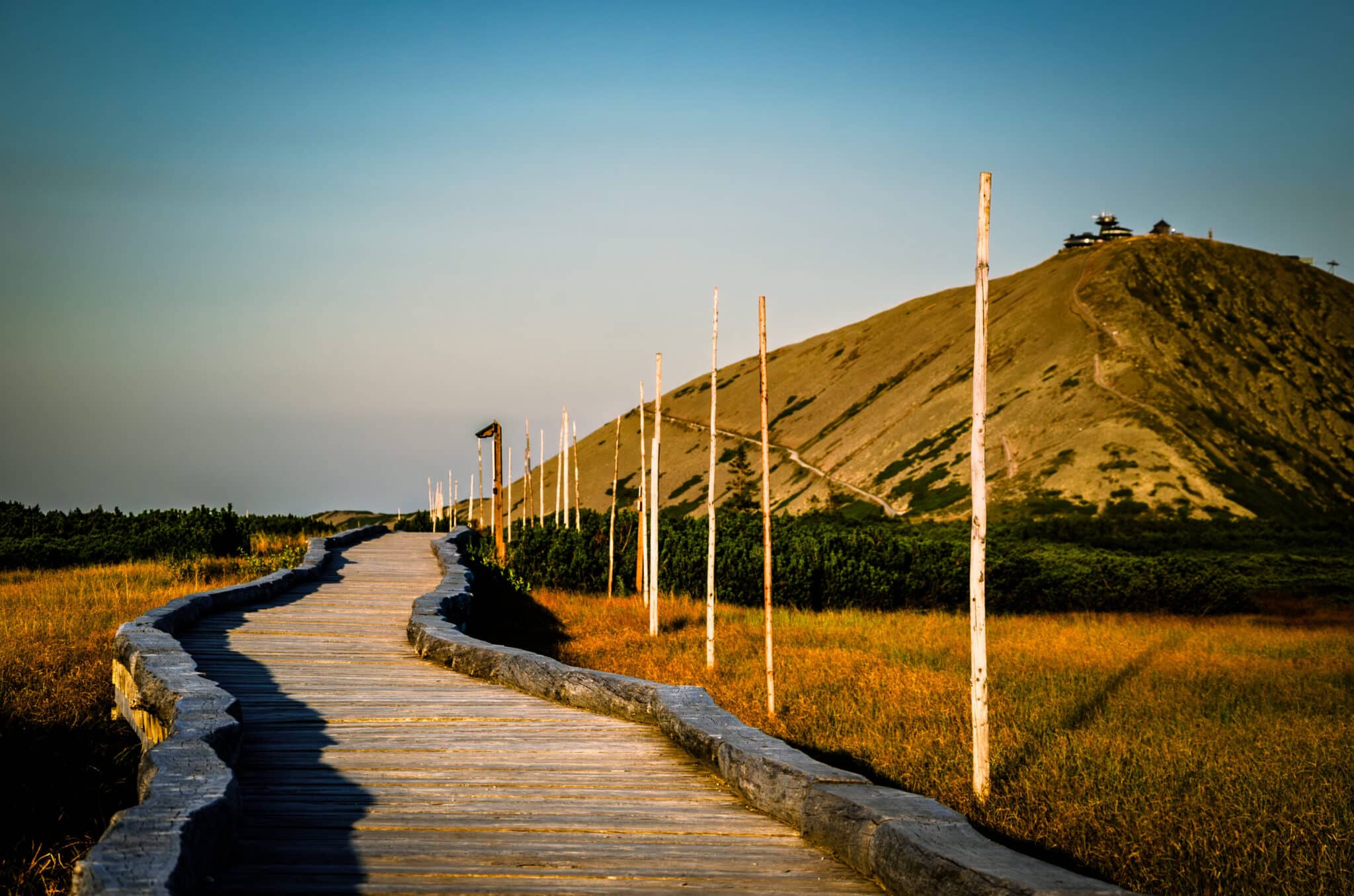 Wooden trail to Śnieżka peak during sunset