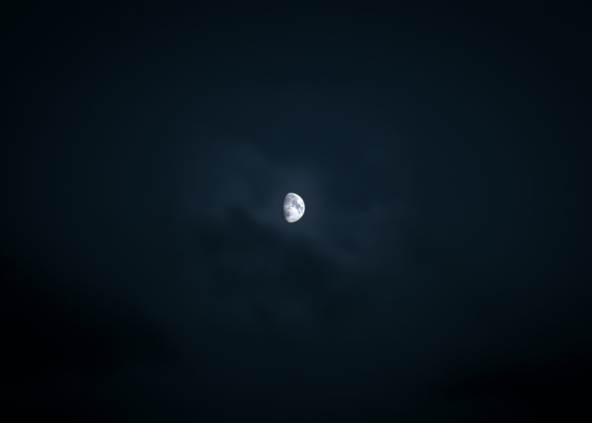 a bright moon against a black sky